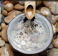 Photo of water flowing into bowl with rocks